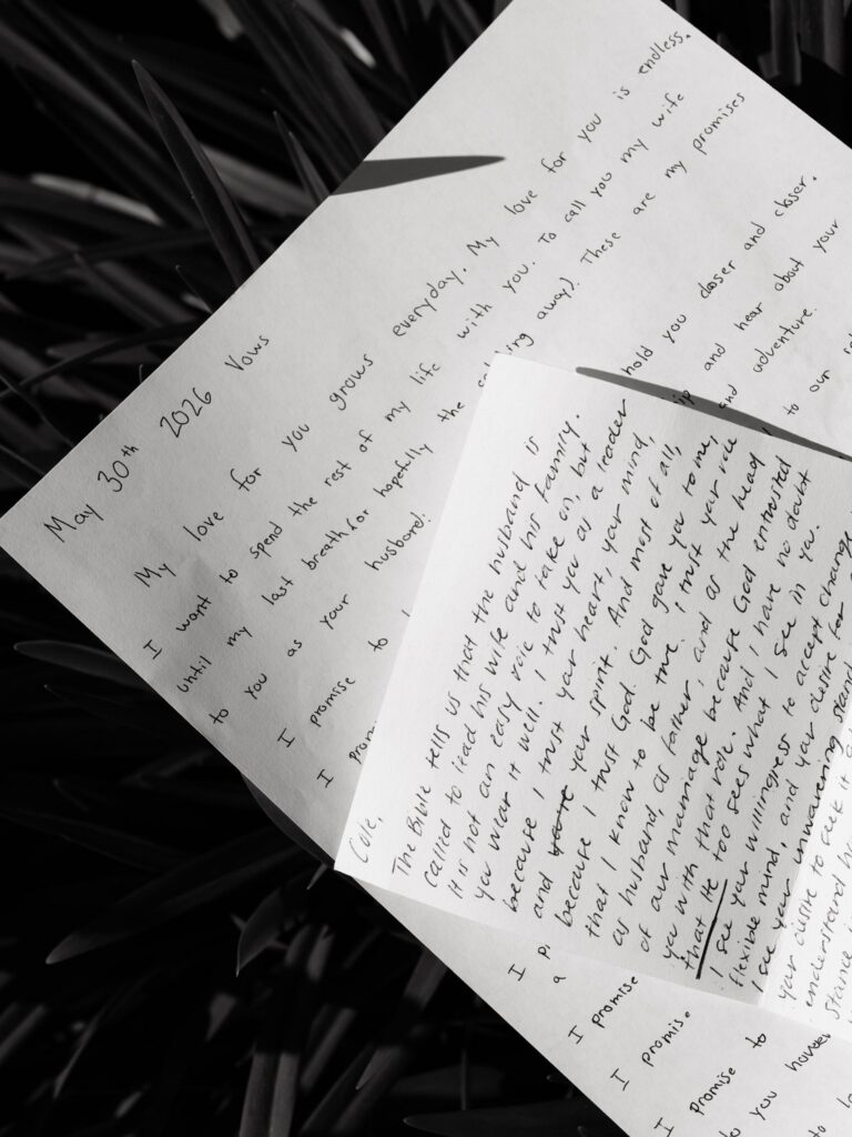 Black and white detail shot of the bride and grooms vows.