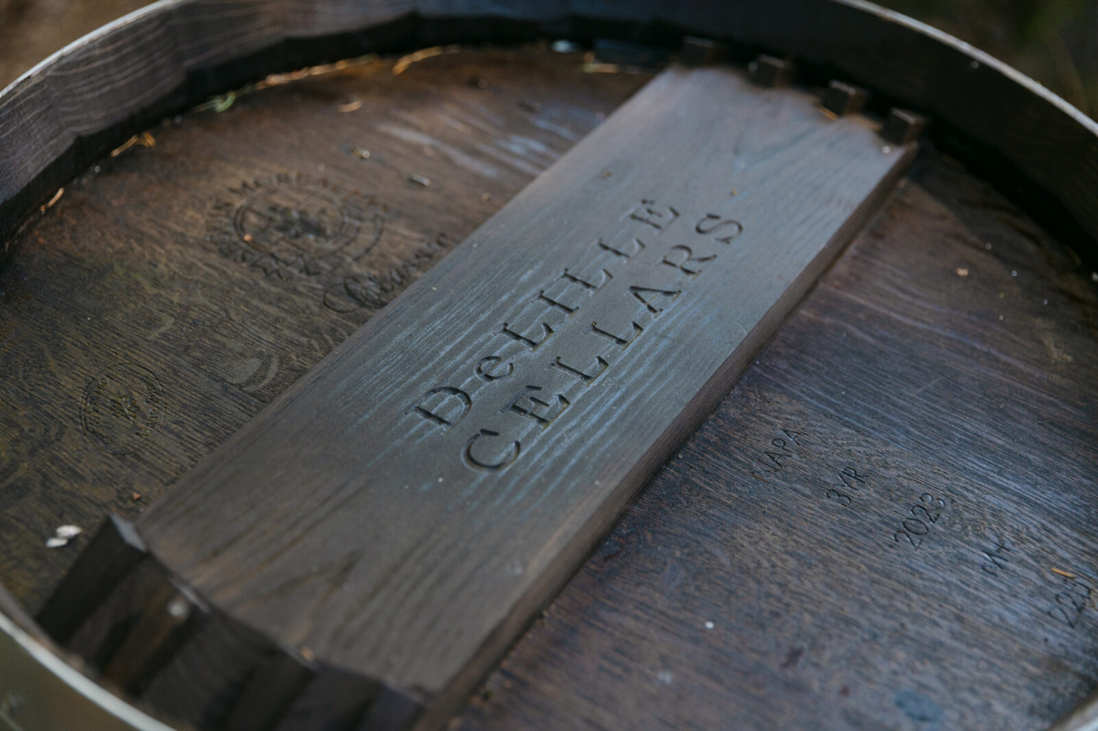Close up shot of a wine barrel that says DeLILLE Cellars.