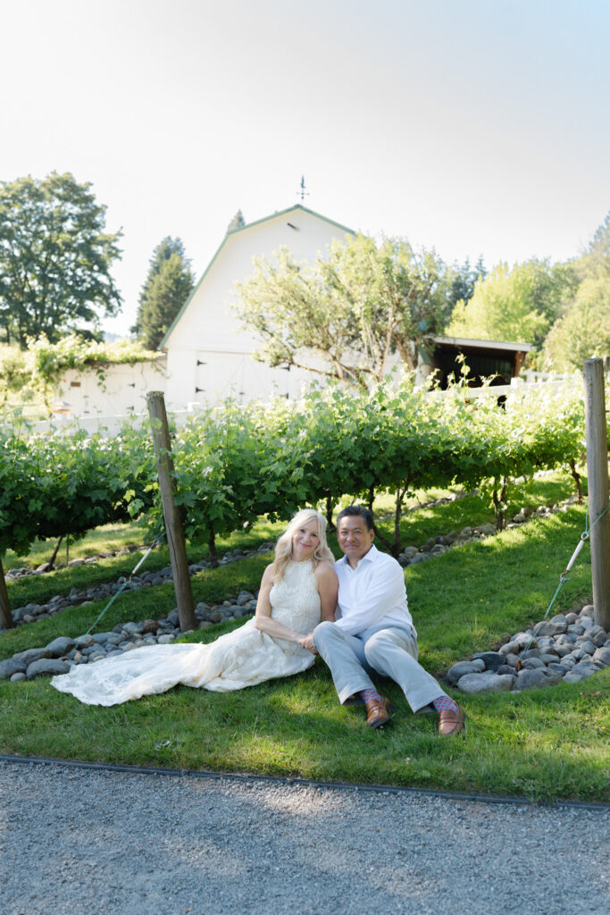 Couple posing in the grass outside of Chateau Lill