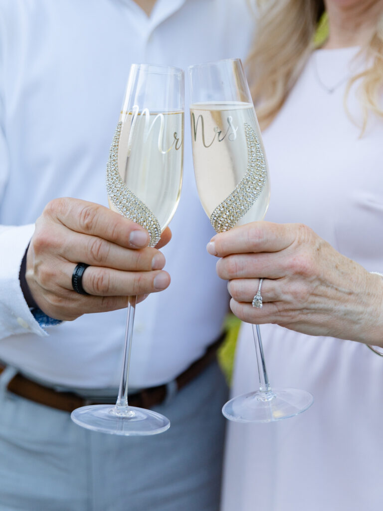 Close up shot of a couple holding glasses of champagne.