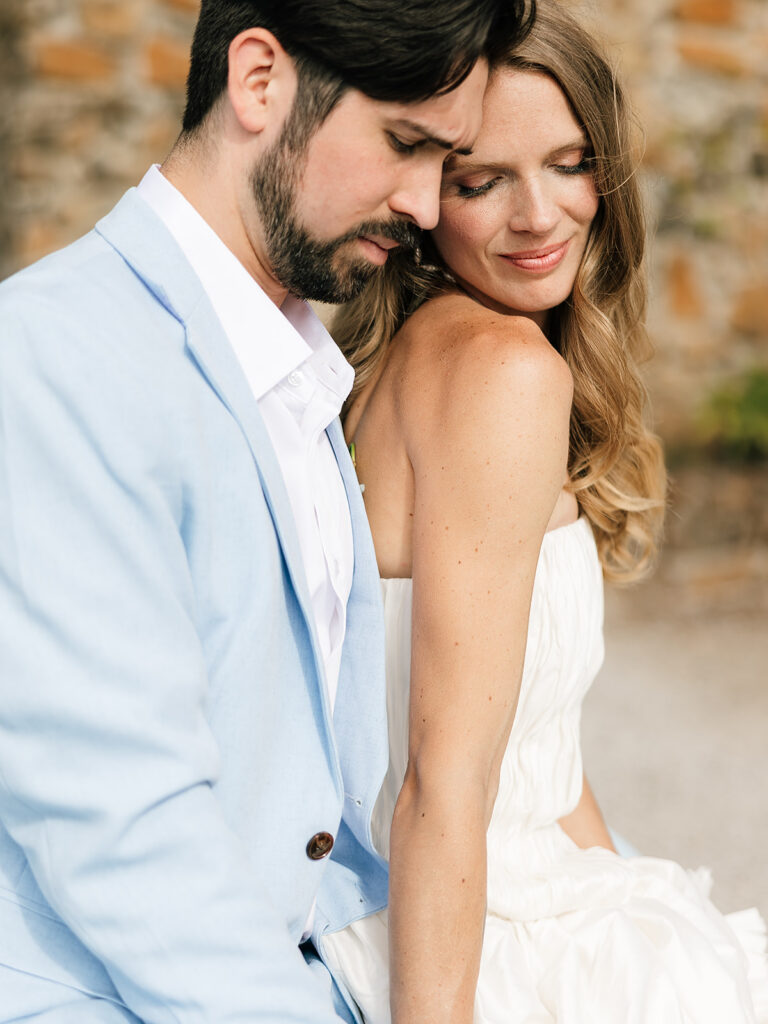 Close up shot of a bride and groom posing close together.