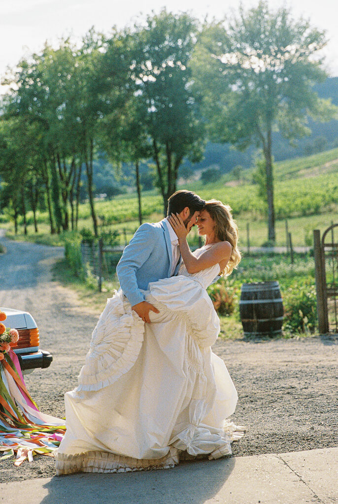 Bride and groom posing close together for their Maysara Winery wedding photos.