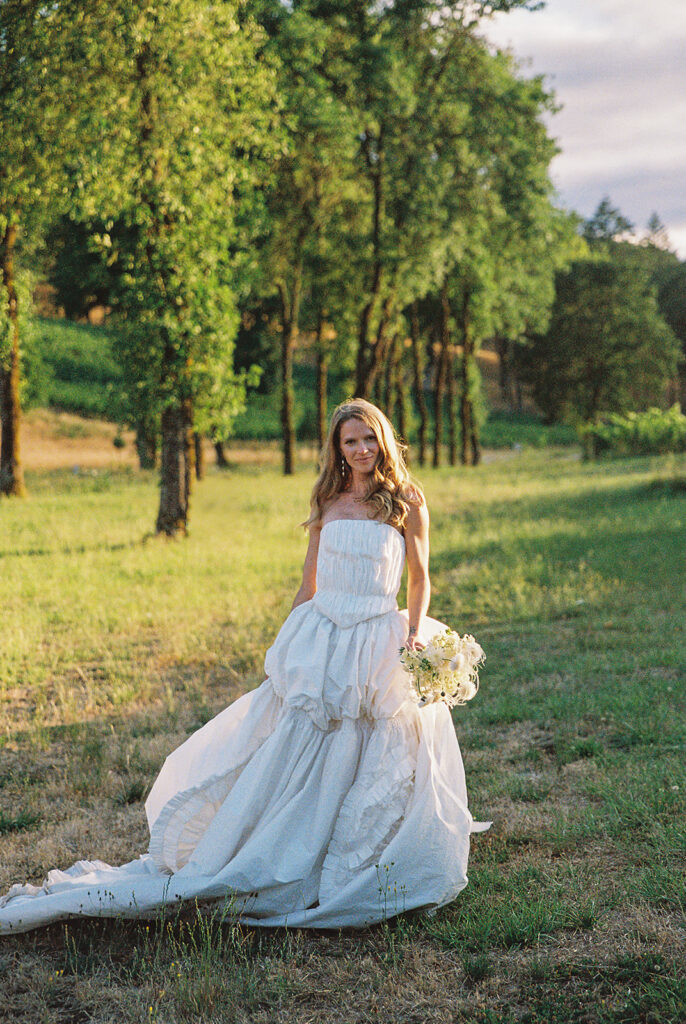 Bride posing outdoors during golden hour.
