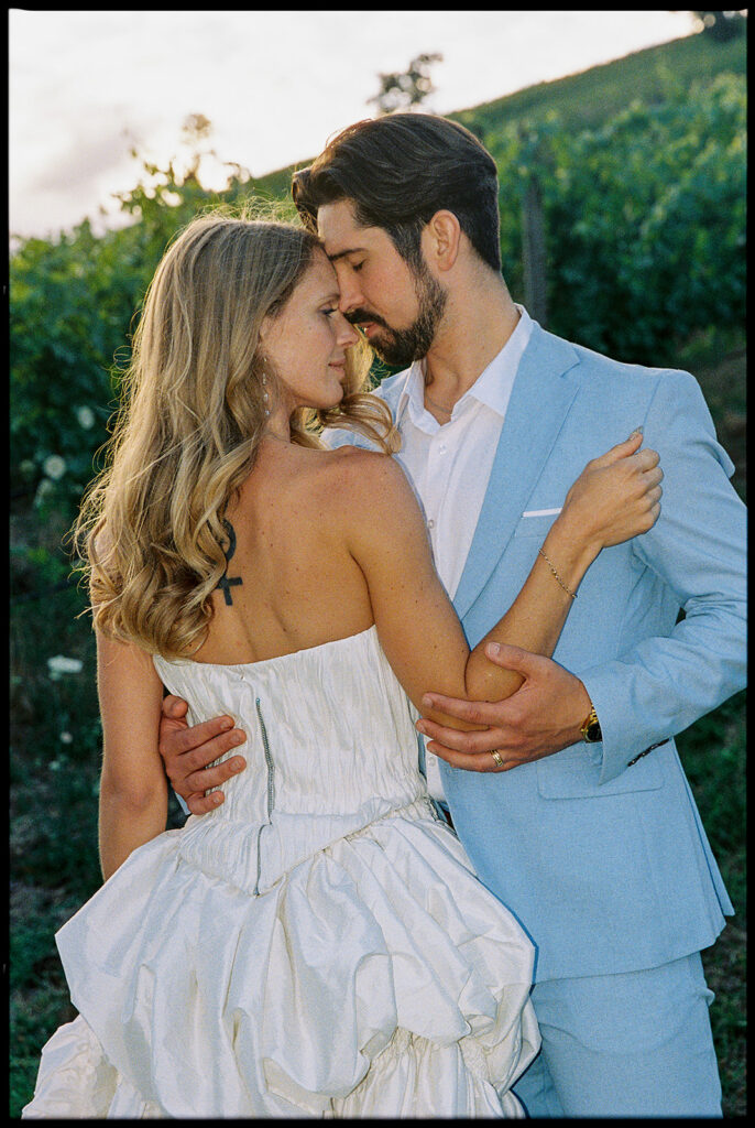 Close up shot of a bride and groom posing near the vineyards at Maysara Winery.