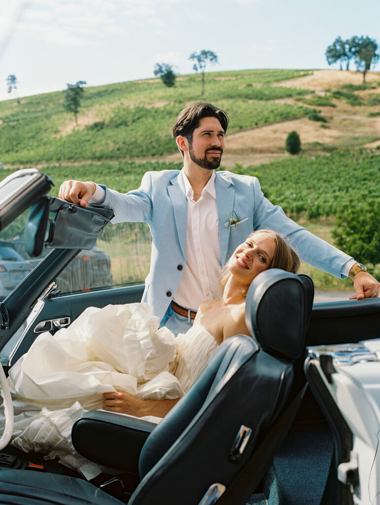 Couple posing with a vintage car at Maysara Winery in Oregon.