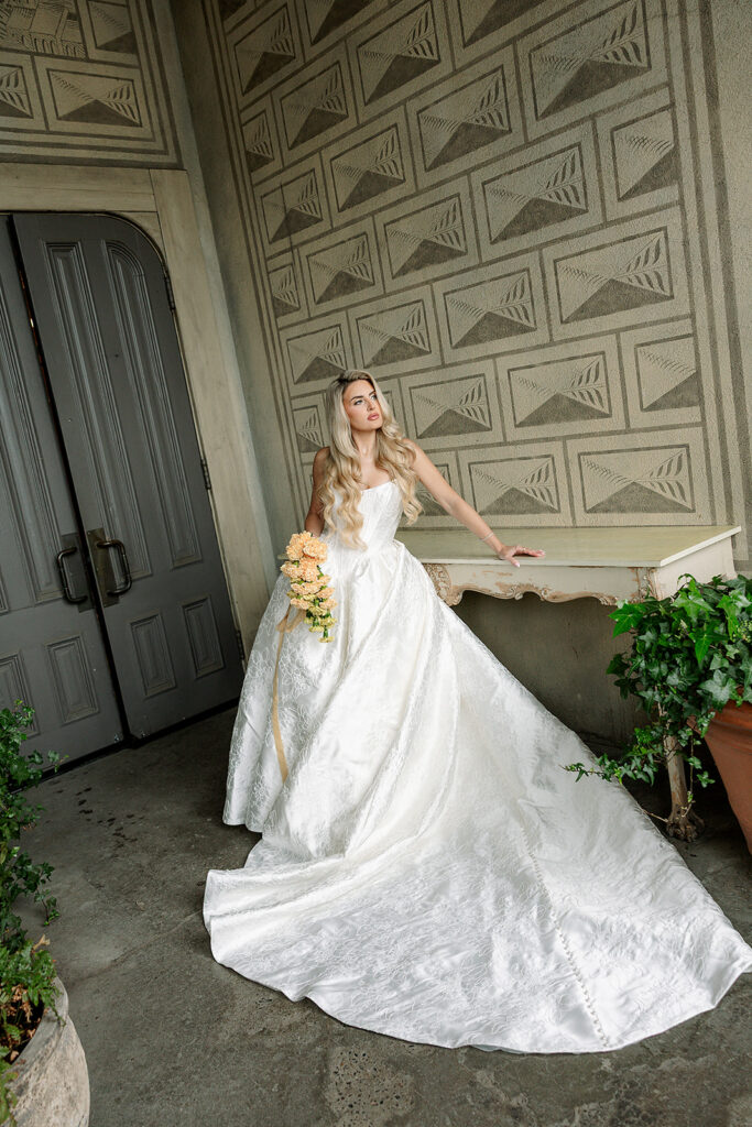 Bride posing in front of a textured wall inside The Ruins in Seattle, WA.