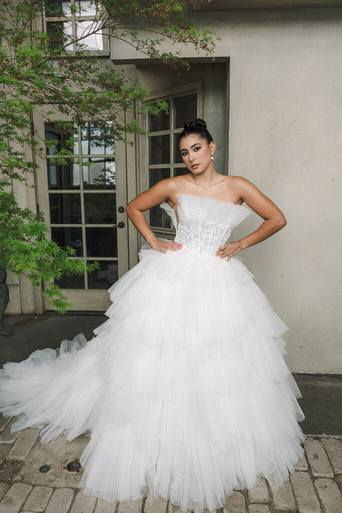 Bride in a dramatic layered tulle wedding gown outside The Ruins.