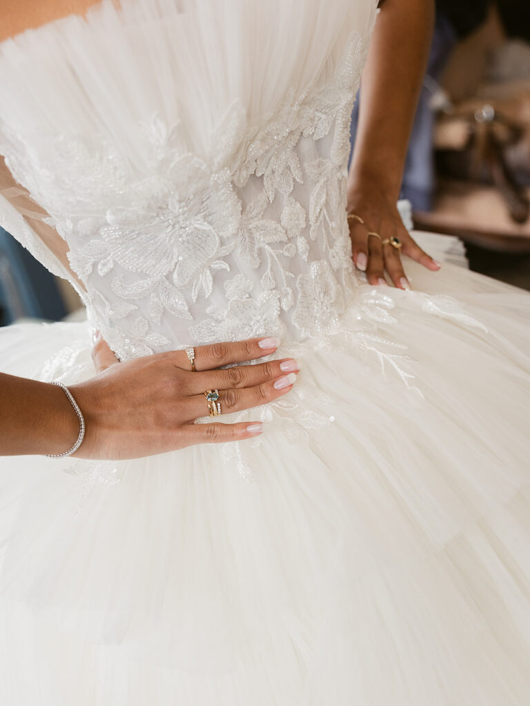 Close up of a bride showing off her rings.