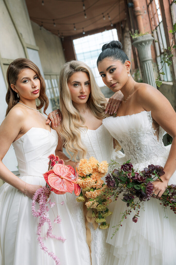 Close up shot of three brides posing inside The Ruins in Seattle, WA for a wedding editorial.