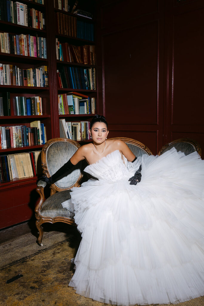 Bride posing in a chair inside The Ruins in Seattle for a wedding editorial.