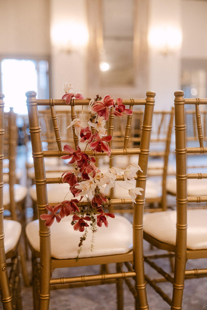Flowers styled on the back of a chair.