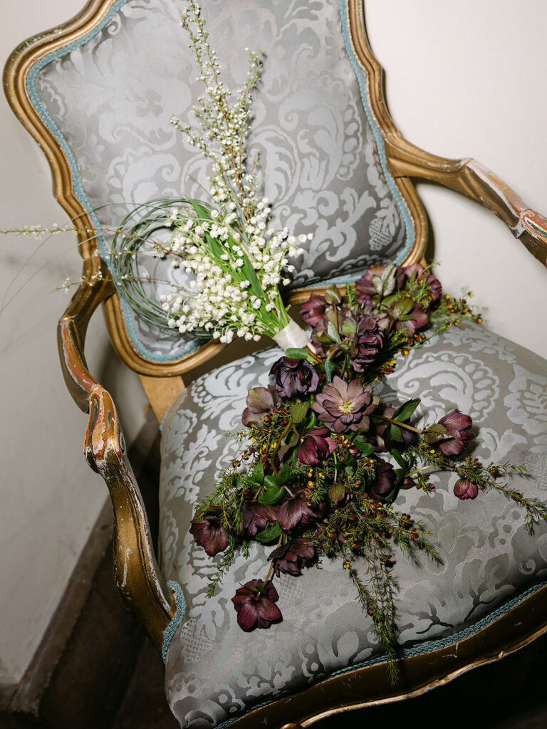Bouquet resting on a blue chair.